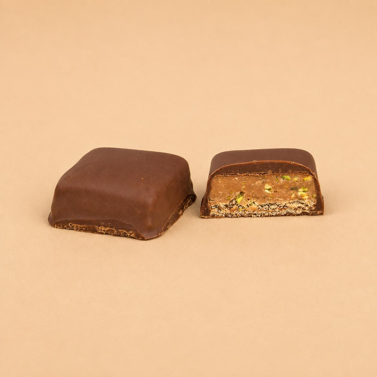 PISTACHIO TOFFEE Pistachio and Toffee mixed and layered on wafer coated with milk chocolate